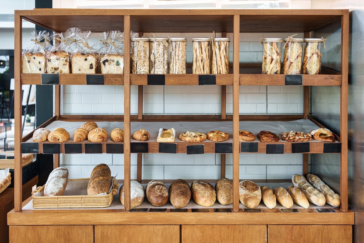 Variety of fresh baked goods and spices displayed on a bakery shelf