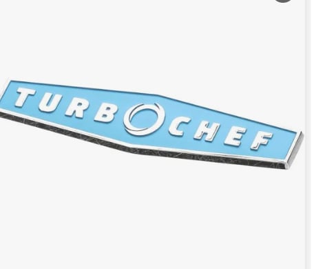 Blue and silver TurboChef emblem badge with chrome detailing on white background