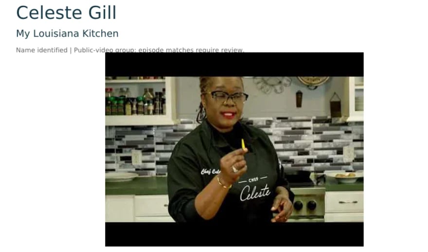 Celeste Gill smiling in her kitchen wearing glasses and a black Celeste branded shirt